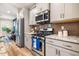 Close up of modern kitchen with stainless steel appliances and subway tile backsplash at 426 Granite Mill Blvd, Chapel Hill, NC 27516