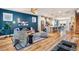 Spacious living room open to the kitchen, featuring a blue accent wall, wood floors, and modern furnishings at 426 Granite Mill Blvd, Chapel Hill, NC 27516