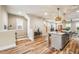 Open living space with office nook, stairs, and kitchen featuring a large island with seating at 426 Granite Mill Blvd, Chapel Hill, NC 27516