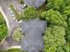 Aerial view of the home showcasing the roof, surrounding trees, and driveway at 4511 Crab Creek Dr # 101, Raleigh, NC 27612