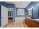 Primary bathroom featuring double sinks and a bathtub with natural light and wood-look flooring at 4511 Crab Creek Dr # 101, Raleigh, NC 27612