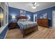 Beautiful bedroom featuring a wooden bed frame, dresser, and light-colored wood flooring at 4511 Crab Creek Dr # 101, Raleigh, NC 27612