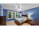 Bedroom features hardwood floors, natural light, a ceiling fan and modern paint at 4511 Crab Creek Dr # 101, Raleigh, NC 27612