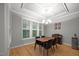 Bright dining room with wood floors, tray ceiling, modern chandelier, and views of the backyard at 4511 Crab Creek Dr # 101, Raleigh, NC 27612