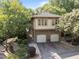 Charming home featuring a stone base, two-car garage, and beautiful landscaping at 4511 Crab Creek Dr # 101, Raleigh, NC 27612