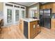Spacious kitchen island provides extra counter space, stainless steel appliances and backyard access at 4511 Crab Creek Dr # 101, Raleigh, NC 27612