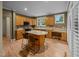 Bright kitchen features an island with seating, built-in desk, and stainless steel appliances at 4511 Crab Creek Dr # 101, Raleigh, NC 27612