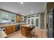 Open kitchen offers a kitchen island with seating, stainless steel appliances, and views of the backyard at 4511 Crab Creek Dr # 101, Raleigh, NC 27612