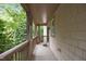 Inviting covered porch featuring wood columns, railings and views of mature trees at 4511 Crab Creek Dr # 101, Raleigh, NC 27612