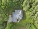 Overhead view of the house, showing the roof, lawn, driveway, and mature surrounding foliage at 517 Belmont Cir, Wake Forest, NC 27587