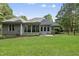 Expansive backyard with lush greenery, patio, and a well-maintained lawn at 517 Belmont Cir, Wake Forest, NC 27587