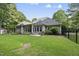 Spacious backyard with lush green grass, bordered by mature trees and a metal fence at 517 Belmont Cir, Wake Forest, NC 27587