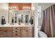 Bright bathroom with a double sink vanity, large mirror, and separate toilet and shower areas at 517 Belmont Cir, Wake Forest, NC 27587
