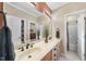 Bathroom featuring a double sink vanity with a large mirror and adjacent bathroom and storage closets at 517 Belmont Cir, Wake Forest, NC 27587