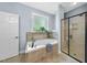Bright bathroom featuring a tiled tub and a glass-enclosed shower at 517 Belmont Cir, Wake Forest, NC 27587