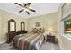 Comfortable bedroom featuring a ceiling fan, dresser with a mirror, and a plush bed with striped bedding at 517 Belmont Cir, Wake Forest, NC 27587