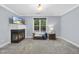 Bonus room featuring a fireplace, large window with wooded views, and neutral carpet at 517 Belmont Cir, Wake Forest, NC 27587