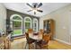 Bright dining room with hardwood floors, round wood table, and large windows with wooded views at 517 Belmont Cir, Wake Forest, NC 27587