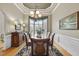 Formal dining room featuring hardwood floors, chair rail, custom millwork, and chandelier at 517 Belmont Cir, Wake Forest, NC 27587