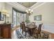 Elegant dining room features hardwood floors, bay window, and chandelier lighting at 517 Belmont Cir, Wake Forest, NC 27587