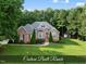 Beautiful brick home with manicured lawn, mature trees, and charming curb appeal at 517 Belmont Cir, Wake Forest, NC 27587