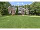 Well-maintained brick home featuring manicured lawn and beautiful landscaping at 517 Belmont Cir, Wake Forest, NC 27587