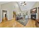Living room with a fireplace, ceiling fan, and hardwood floors at 517 Belmont Cir, Wake Forest, NC 27587