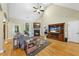 Cozy living room with hardwood floors, vaulted ceiling, fireplace, and natural light at 517 Belmont Cir, Wake Forest, NC 27587
