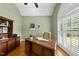Comfortable home office with hardwood floors, large window, and custom built-in cabinetry at 517 Belmont Cir, Wake Forest, NC 27587