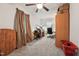 Bedroom with carpet, brown curtains, desk, chair, and brown storage closet at 520 Park Ave, Rocky Mount, NC 27801