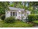 Quaint single-story home with a welcoming front porch and lovely green landscaping and trees at 520 Park Ave, Rocky Mount, NC 27801