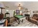 Spacious game room featuring a pool table, fireplace, and wood-look floors at 520 Park Ave, Rocky Mount, NC 27801