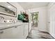 Bright laundry room with washer, dryer, and door to outside at 520 Park Ave, Rocky Mount, NC 27801
