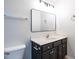 Updated bathroom features black vanity, white countertop and stainless fixtures at 5225 Big Bass Dr, Raleigh, NC 27610