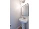 Half bath with pedestal sink, white fixtures, and modern mirror at 5225 Big Bass Dr, Raleigh, NC 27610