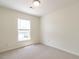 A sunlit bedroom with neutral carpet and a window at 5225 Big Bass Dr, Raleigh, NC 27610