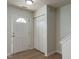 Inviting entryway with a white door, wood-look flooring, and ample closet space at 5225 Big Bass Dr, Raleigh, NC 27610