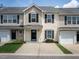 Charming townhome featuring a well-manicured lawn, black shutters, and a gray roof at 5225 Big Bass Dr, Raleigh, NC 27610