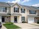 Charming townhome with black shutters, well-manicured lawn, and private driveway at 5225 Big Bass Dr, Raleigh, NC 27610