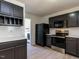 Updated kitchen with black cabinets, stainless steel appliances and view to laundry at 5225 Big Bass Dr, Raleigh, NC 27610