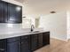 Open Kitchen concept showcasing stone countertops, black cabinetry, and modern fixtures at 5225 Big Bass Dr, Raleigh, NC 27610