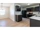 Well-lit kitchen featuring dark cabinets, stainless steel appliances, and bright countertops at 5225 Big Bass Dr, Raleigh, NC 27610