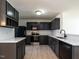 Modern kitchen features black cabinets, stainless appliances and stone countertops at 5225 Big Bass Dr, Raleigh, NC 27610
