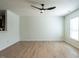 Large living area with wood-look flooring, modern fan, and lots of natural light at 5225 Big Bass Dr, Raleigh, NC 27610
