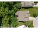 Aerial shot featuring a home with a sunroom, lots of trees and nearby neighboring properties at 534 Siltstone Pl, Cary, NC 27519