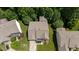 Aerial view of home with a large roof and green lawn with surrounding trees at 534 Siltstone Pl, Cary, NC 27519