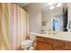 Bright bathroom featuring a sink vanity, toilet, shower curtain, and tile floors at 534 Siltstone Pl, Cary, NC 27519
