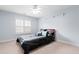 Cozy bedroom featuring a bed with decorative pillows, carpet floors, and a ceiling fan at 534 Siltstone Pl, Cary, NC 27519