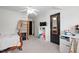 Bright bedroom with carpet flooring, ceiling fan, shelving, and a closet at 534 Siltstone Pl, Cary, NC 27519