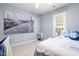 Bright bedroom featuring a modern art piece, a window, and carpet floors at 534 Siltstone Pl, Cary, NC 27519